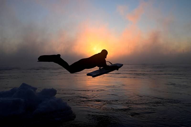 Carlos Hebert Plante dives into freezing water to use his boogie board as extreme cold weather hits Montreal, Canada. It was minus 22°C as the sun rose above the St Lawrence River. Reuters