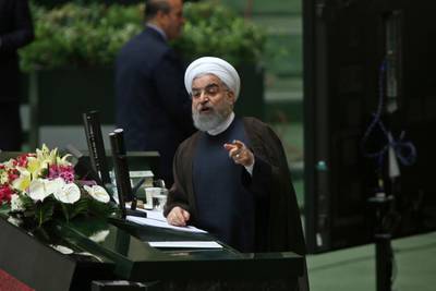 Iranian President Hassan Rouhani speaks in a session of parliament to debate his proposed cabinet, in Tehran, Iran, Tuesday, Aug. 15, 2017. Iran's president issued a direct threat to the West on Tuesday, claiming his country is capable of restarting its nuclear program within hours â€” and quickly bringing it to even more advanced levels than in 2015, when Iran signed the nuclear deal with world powers. (AP Photo/Vahid Salemi)