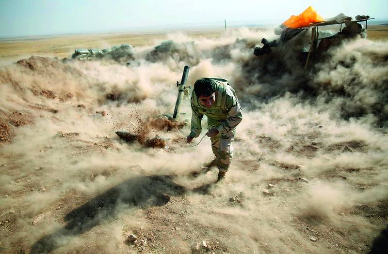 A Kurdish peshmerga fighter launching mortar shells towards Zummar, controlled by ISIS, near Mosul on September 15. Reuters