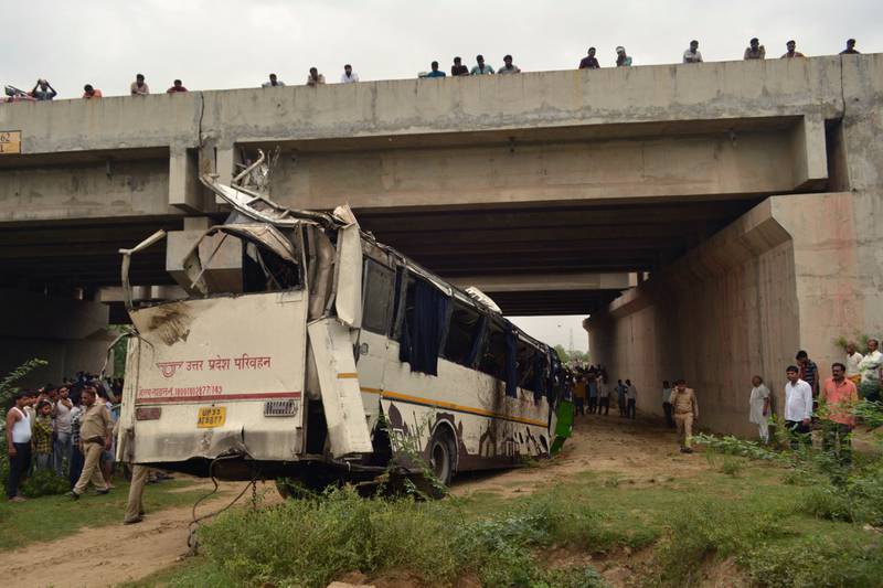 Onlookers and police gather around a bus that careened off the Delhi-Agra expressway, one of India’s busiest roads. At least 29 people were killed in the crash, on July 8, 2019. AFP