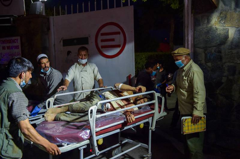 Medical and hospital staff bring an injured man on a stretcher for treatment after a powerful explosion in Kabul. AFP