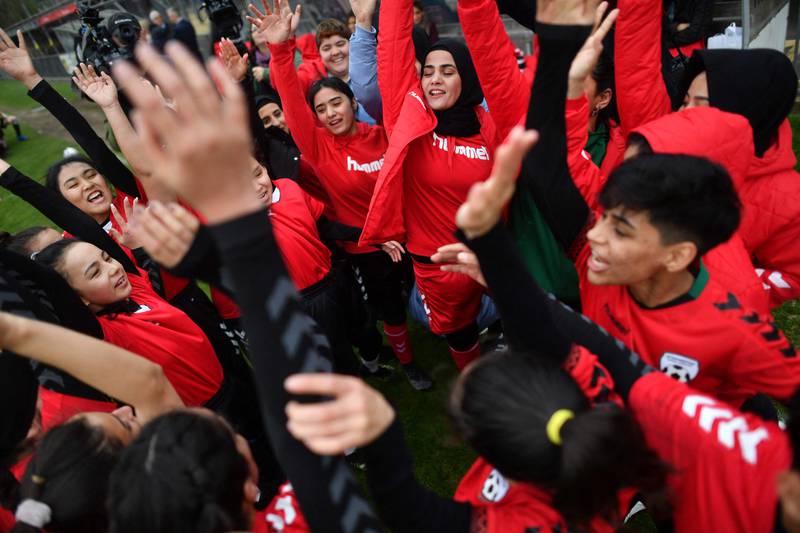 Afghan women footballers have a team talk before their development squad played the women’s parliamentary team on Tuesday, at the Dulwich Hamlet FC ground, in London, as part of Amnesty’s annual Football Welcomes month. AFP