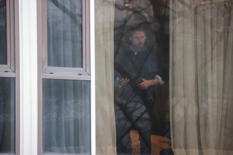 A man looks through a window of the Radisson Blu Hotel at Heathrow Airport. Reuters