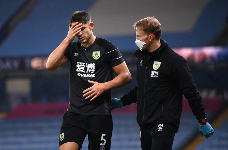 Burnley's James Tarkowski reacts after colliding with Manchester City goalkeeper Ederson. PA