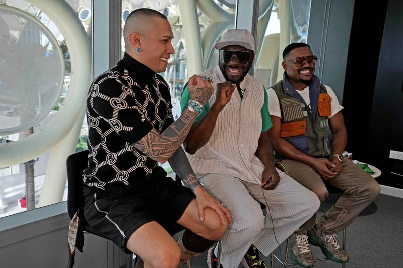Taboo, left, fist-bumps will.i.am as the band meet the press at the Expo site. AP