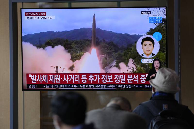People watch a TV screen showing a news programme reporting North Korea's missile launch with file footage at a train station in Seoul, South Korea, on Tuesday. AP