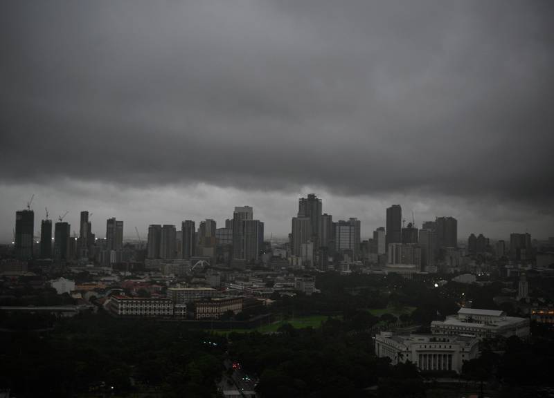 Dark clouds hang over Manila. AFP