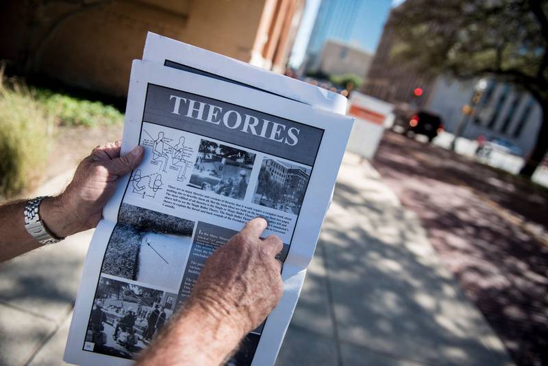 An unofficial tour guide shows assassination theories outside the former Texas School Book Depository in Dealey Plaza, Dallas, Texas.  AFP
