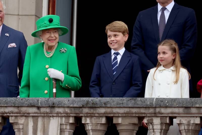 Prince George stands alongside the queen and his younger sister Princess Charlotte on the balcony of Buckingham Palace during the Platinum Jubilee celebrations in June. Getty Images