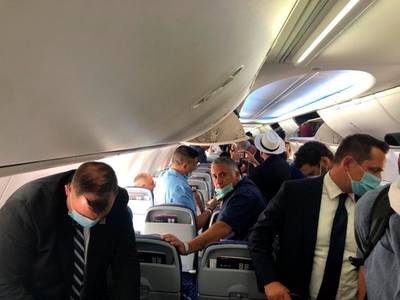 Reporters, Israeli and US delegates travelling on an Israeli El Al airliner prepare to disembark on arrival in Abu Dhabi. AP