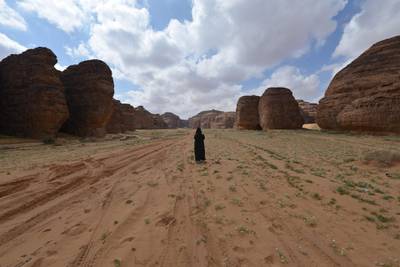 A Saudi woman walks in the Sharaan Nature Reserve near the town of al-Ula in northwestern Saudi Arabia on February 11. 2019.  / AFP / FAYEZ NURELDINE
