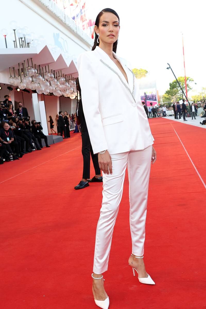 Model Sofia Resing wears a white suit with an embellished lapel. Getty Images