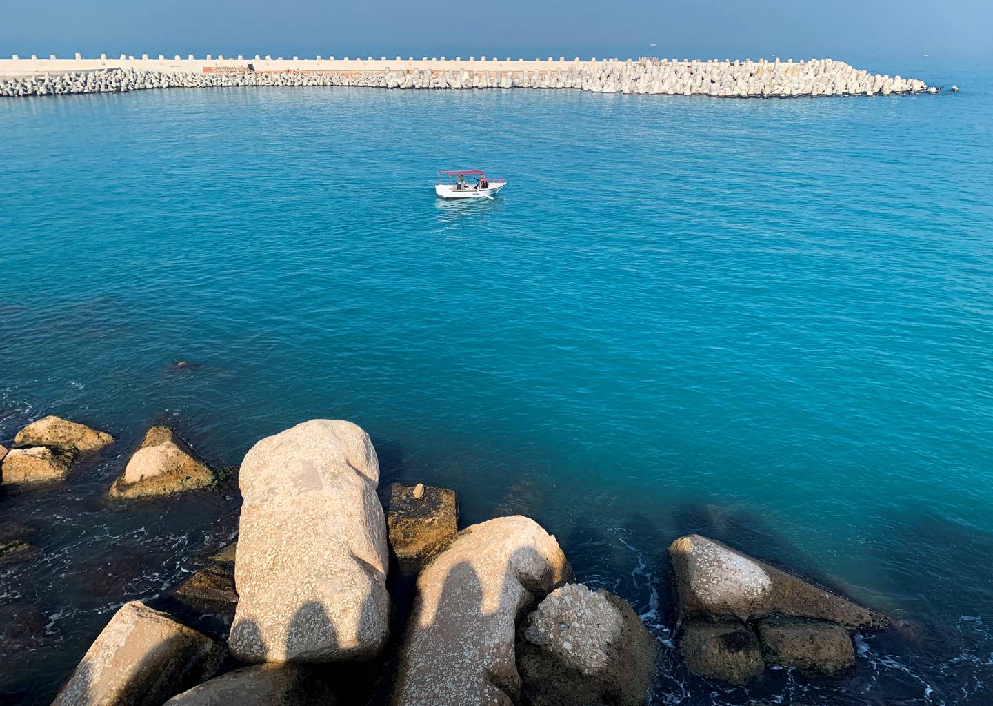 A fishing boat is seen near a newly constructed concrete barrier constructed to protect Alexandria's shoreline. Reuters 