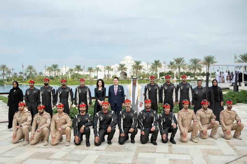 Sheikh Mohamed, Mr Yoon and Ms Kim with members of Al Forsan aerobatic team