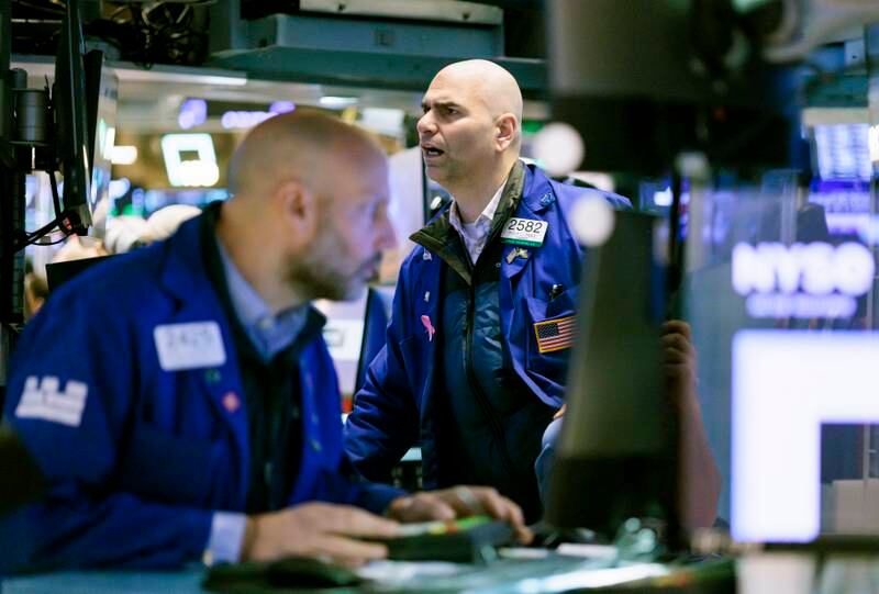 Traders work on the floor of the New York Stock Exchange. Wall Street indices settled higher despite choppy trade on Friday, as investors held out hope that the Fed would change their strategy on interest rates. EPA