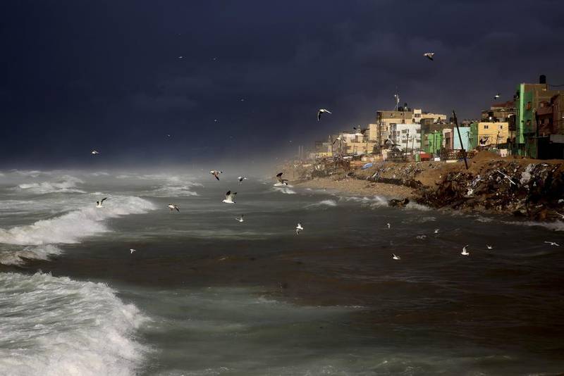Seagulls fly over the Mediterranean Sea on December 27, 2016, during a rainstorm along the coast off the Shati refugee camp in Gaza City. Adel Hana / Associated Press