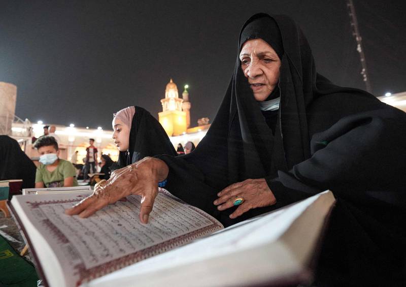 A woman reads the Quran at the Grand Mosque of Kufa near the central shrine city of Najaf, about 160 kilometres south of Iraq's capital Baghdad, during the month of Ramadan. AFP