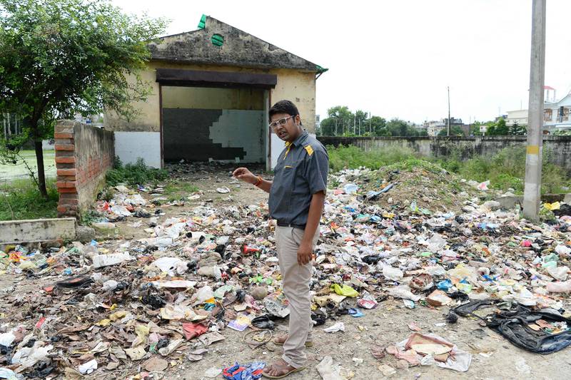 Durgesh Mishra stands near a dumpsite as he speaks during an interview in Gonda district, in the Indian state of Uttar Pradesh. Sajjad Hussain / AFP
