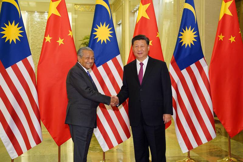 Malaysia Prime Minister Mahathir Mohamad shakes hands with President of the People's Republic of China Xi Jinping at the Diaoyutai State Guesthouse in Beijing. AFP