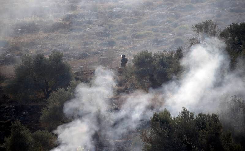 An Israeli soldier stands guard after a protest against the settler outpost of Evyatar in Beita village near Nablus. EPA