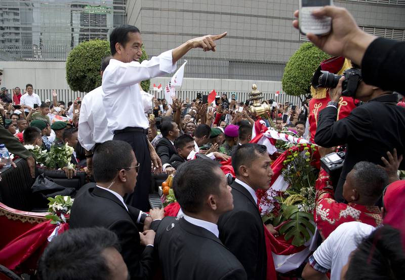 Indonesian president Joko Widodo meets the crowds in a street parade in Jakarta after his inauguration on October 20, 2014. Mark Baker/AP Photo