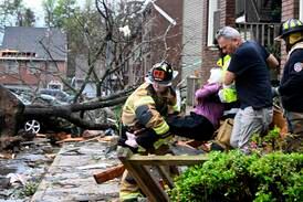 Firefighters carry a woman out of a condominium complex that was damaged by a tornado in Little Rock, Arkansas. Arkansas Democrat-Gazette via AP
