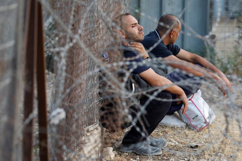 Palestinian workers in Israel strike against Israel and Palestinian Authority's recent agreement to have their wages transferred to bank accounts, at an Israeli checkpoint in Tulkarm the Israeli-occupied West Bank on Sunday. Reuters