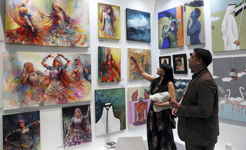 DUBAI , UNITED ARAB EMIRATES , April 3 – 2019 :-  Visitors looking at the art works which are on display at the Uchaan stand at the World Art Dubai 2019 held at Dubai World Trade Centre from 3rd to 6th April in Dubai. ( Pawan Singh / The National ) For News/Online/Instagram