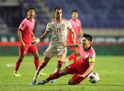 South Korea attacker Son Heung-min goes down under a challenge from Caio Canedo. Reuters