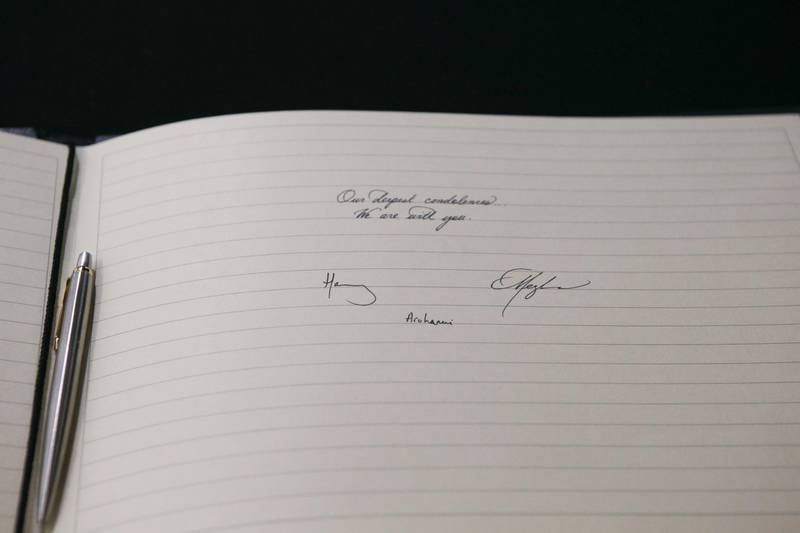 A picture shows the message written and signed by Meghan, Duchess of Sussex and Prince Harry, Duke of Sussex at the New Zealand High Commission in London. AFP