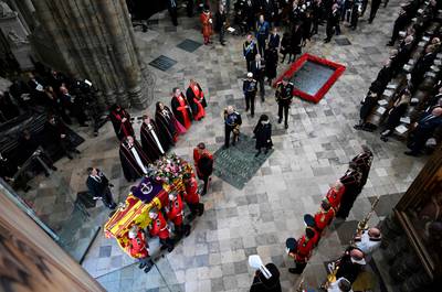 The Bearer Party of The Queen's Company, 1st Battalion Grenadier Guards carries the coffin from Westminster Abbey. AFP