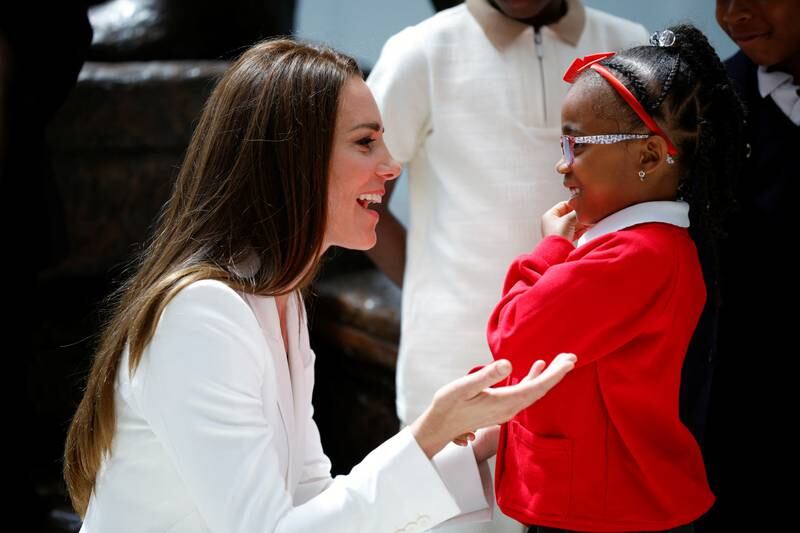 A young girl is captivated by a chat with the Duchess of Cambridge at the unveiling of Britain's National Windrush Monument. Getty Images