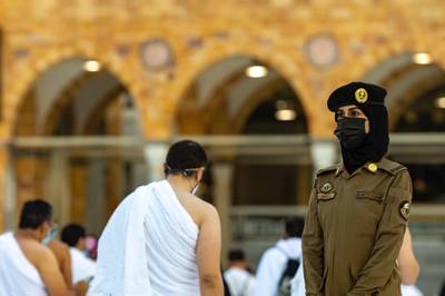 A Saudi officer stands inside a mosque.  Saudi Arabia set a target to increase women’s participation in the workforce from 22% to 30% as part of its Vision 2030 plan to overhaul the economy. Courtesy Saudi Interior Ministry. 