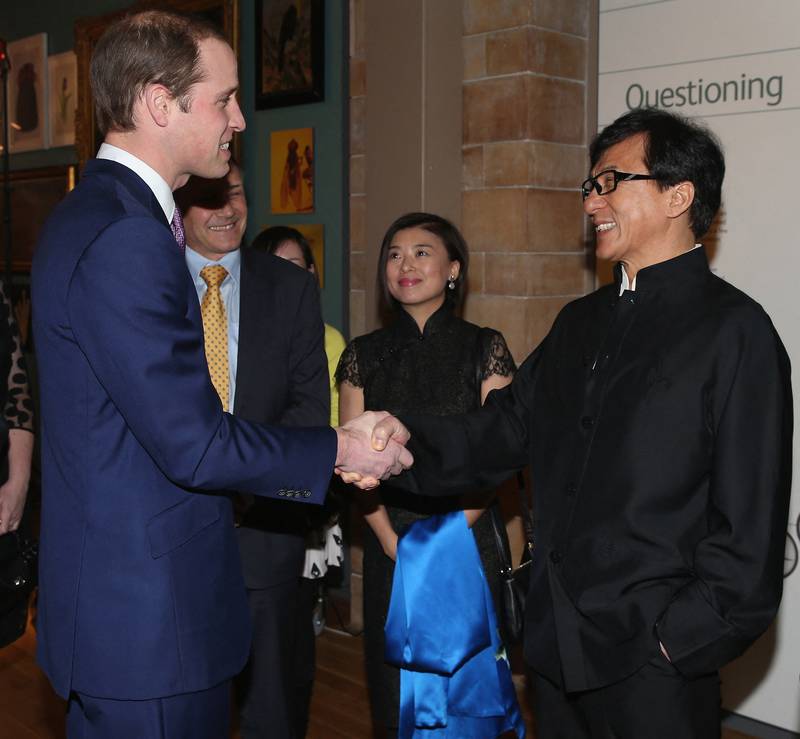 Prince William meets actor Jackie Chan during a reception for the Illegal Wildlife Trade conference at the Natural History Museum in London on February 12, 2014. AFP