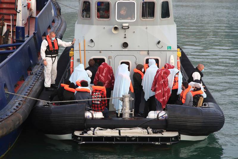 A group of people thought to be migrants are brought in to the harbour in Dover, Kent, England following a small boat incident in the English Channel earlier this morning, Thursday June 3, 2021. (Gareth Fuller/PA via AP)