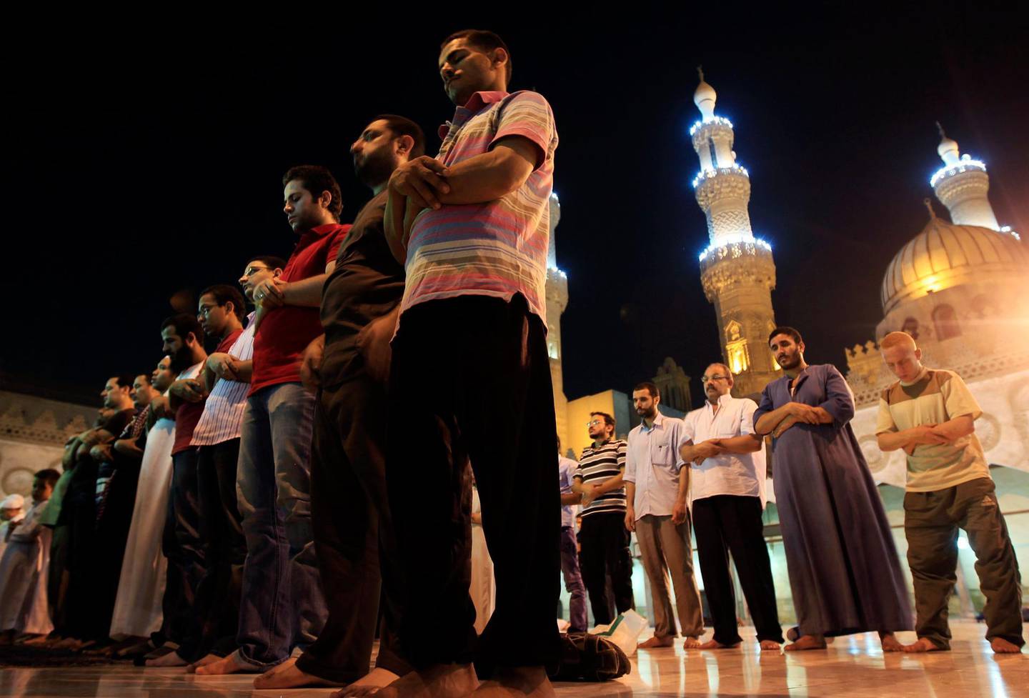 Muslim men attend an evening prayer called "Tarawih" to mark the beginning of the holy fasting month of Ramadan, at Al Azhar mosque in Cairo July 31, 2011. Millions of Muslims worldwide celebrate on Monday the beginning of Ramadan, the holiest month in the Islamic calendar when Muslims abstain from eating, drinking and conducting sexual relations from sunrise to sunset. REUTERS/Amr Abdallah Dalsh  (EGYPT - Tags: SOCIETY RELIGION) *** Local Caption ***  AMR001_EGYPT_0801_11.JPG