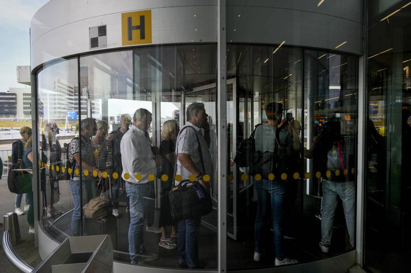 Travellers queue to check in and board flights at Amsterdam's Schiphol Airport. It was the eighth worst airport in Europe, with 61 per cent of flights 
delayed and 5.2 per cent cancelled. AP