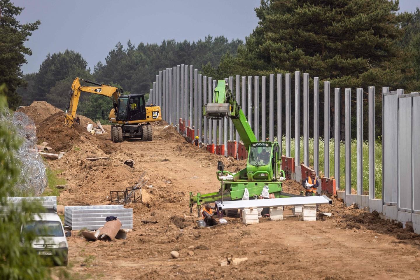 Workers finishing the border wall. AFP