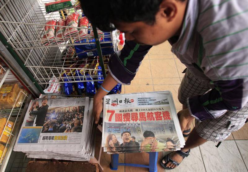 A vendor prepares newspapers leading with Saturday’s missing Malaysian Airlines plane, in Shah Alam, outside Kuala Lumpur, Malaysia. An international fleet of planes and ships scouted the waters between Malaysia and Vietnam for any clues to the fate of the Malaysian Airlines Boeing 777, which disappeared less than an hour after taking off from Kuala Lumpur bound for Beijing. Lai Seng Sin / AP Photo