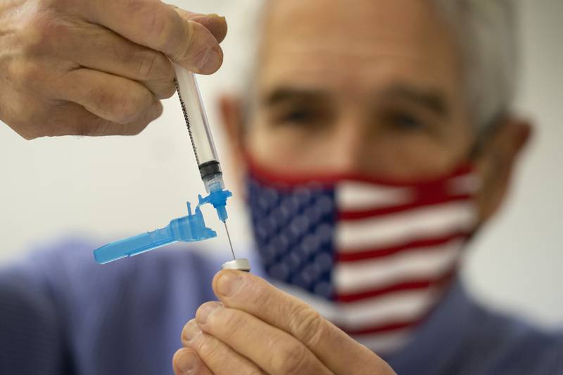 Dr Sydney Sewall fills a syringe with a Covid-19 vaccine at a clinic in Augusta, Maine, US. AP