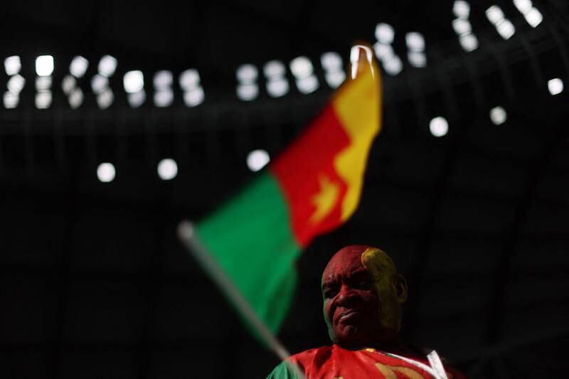 A Cameroon fan waves his flag inside the stadium. Reuters