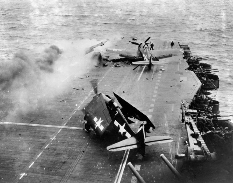 Damaged aircraft on the flight deck of the 'USS Saratoga' after direct hits by Japanese bombs off Iwo Jima during the Second World War. Getty Images