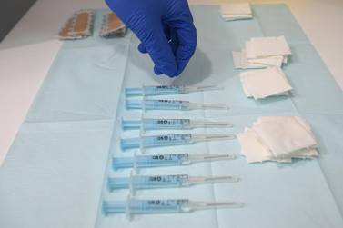 A nurse prepares to administer AstraZeneca Covid-19 vaccines. AFP