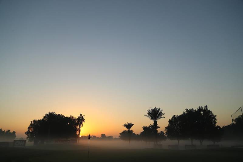 Fog engulfs the 17th green at the Emirates Golf Club. Getty
