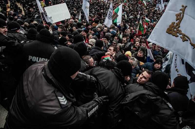 Protesters clash with police as they try to enter the National Assembly building during a protest against certificates and vaccinations in Sofia. Bulgaria has the EU's lowest vaccination rates and less than 30 per cent of its population has received two doses. More than 31,000 have died since the pandemic began in this country of 6.5 million - one of the highest death rates in the world. Getty Images