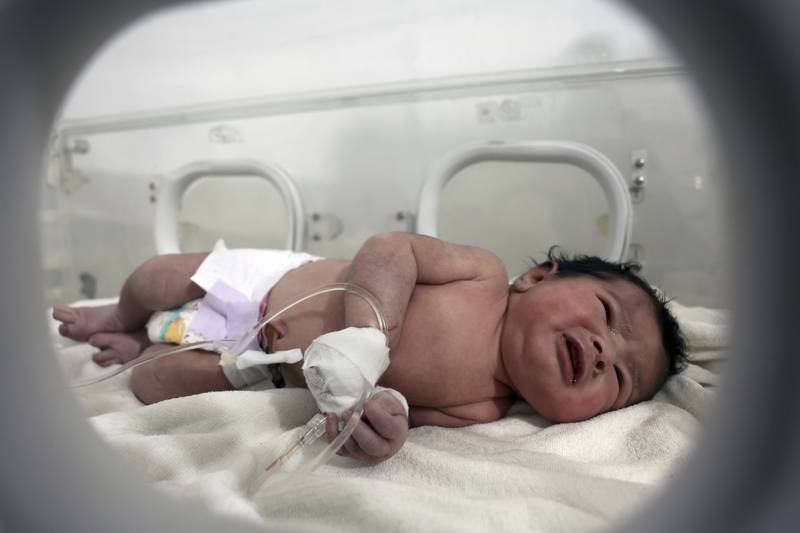 Aya, who was born under the rubble caused by the earthquake that hit Syria and Turkey on February 6, receives treatment at a children's hospital in Afrin, Syria.  AP Photo