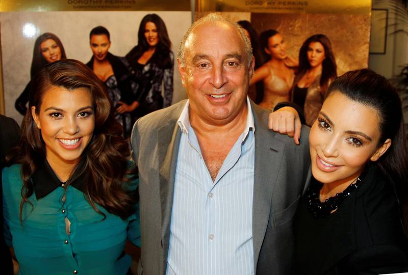 Kourtney and Kim Kardashian pose with Philip Green before the launch of their clothing line, Kardashian Kollection, at Dorothy Perkins in London in 2012. Reuters