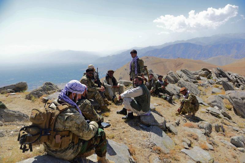 Afghan resistance movement and anti-Taliban uprising forces rest on a hilltop in Darband. AFP