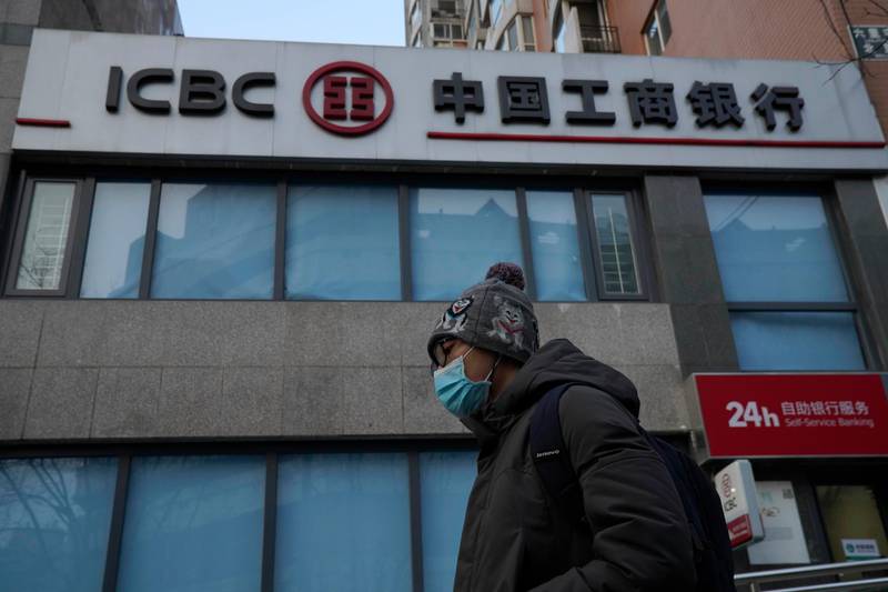 A man passes by an Industrial and Commercial Bank of China (ICBC) branch in Beijing Tuesday, Jan. 19, 2021. Profit at state-owned companies that dominate China's banking, oil and most other industries rose by as much as 25% last year as the country recovered from the coronavirus pandemic, according to the. State-Owned Assets Supervision and Administration Commission which oversees 97 companies directly under the Cabinet including PetroChina Ltd., Asia's biggest oil producer; China Mobile Ltd., the world's biggest phone carrier by number of subscribers, and Industrial and Commercial Bank of China Ltd., the world's biggest bank by assets. (AP Photo/Ng Han Guan)