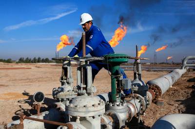 FILE - In this Thursday, Jan. 12, 2017 file photo, a worker operates valves in Nihran Bin Omar field north of Basra, Iraq. An Iraqi oil official says employees of energy giant Exxon Mobil have started evacuating an oil field in the southern province of Basra, amid rising tensions between the United States and Iran. The first group left two days ago and another batch left early Saturday May 18, 2019. (AP Photo/Nabil al-Jurani, File)
